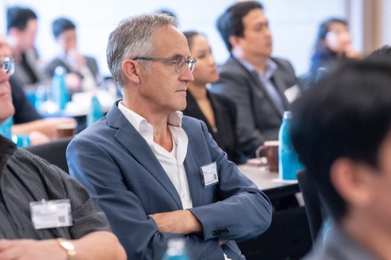 Delegates listening at a forum