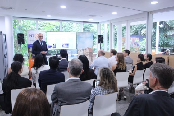 A speaker presenting to a seated audience
