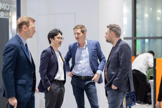 Four guests standing in conversation