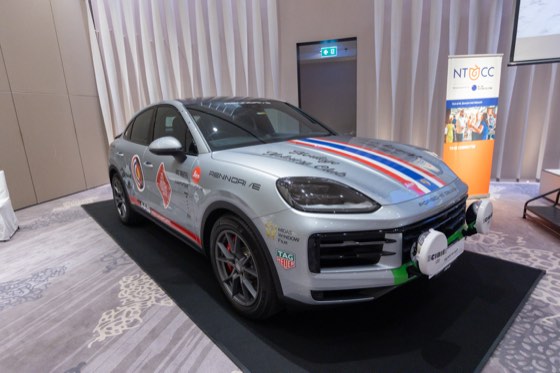 A rally-liveried Porsche on display in a function room