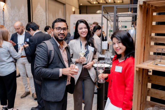 Three guests smiling at a reception