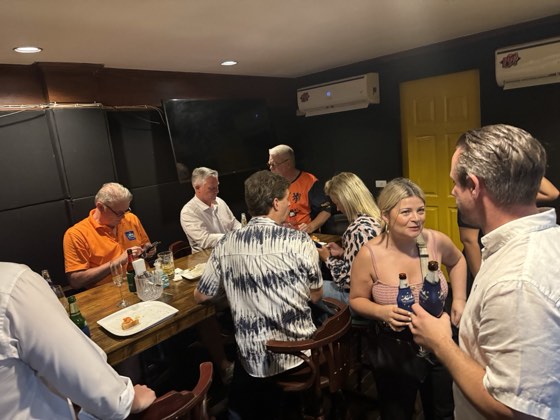 Guests talking around a table in a bar